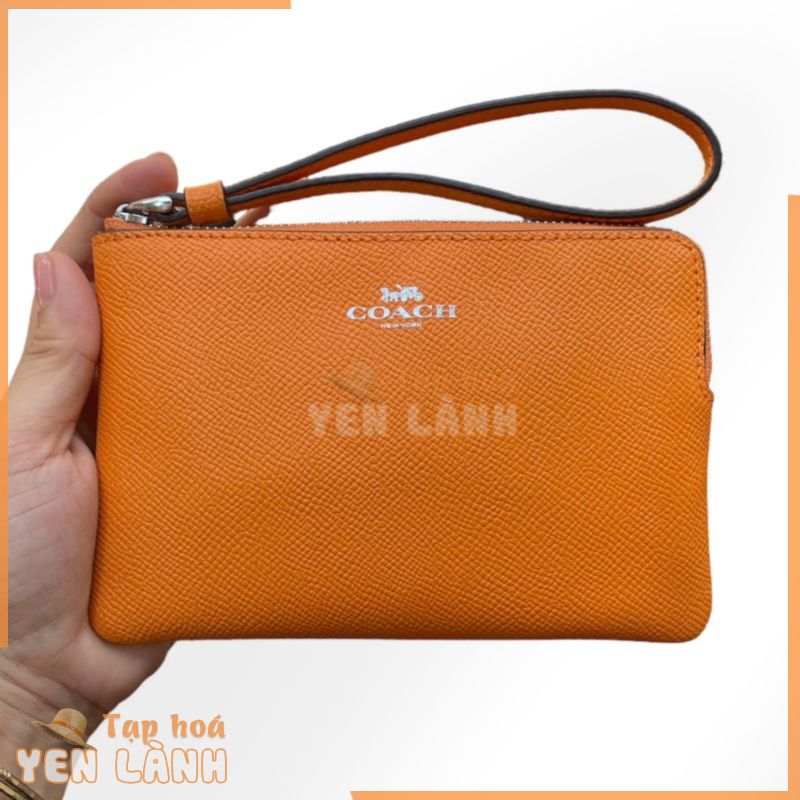 Ví cầm tay có quai Coach New York màu cam